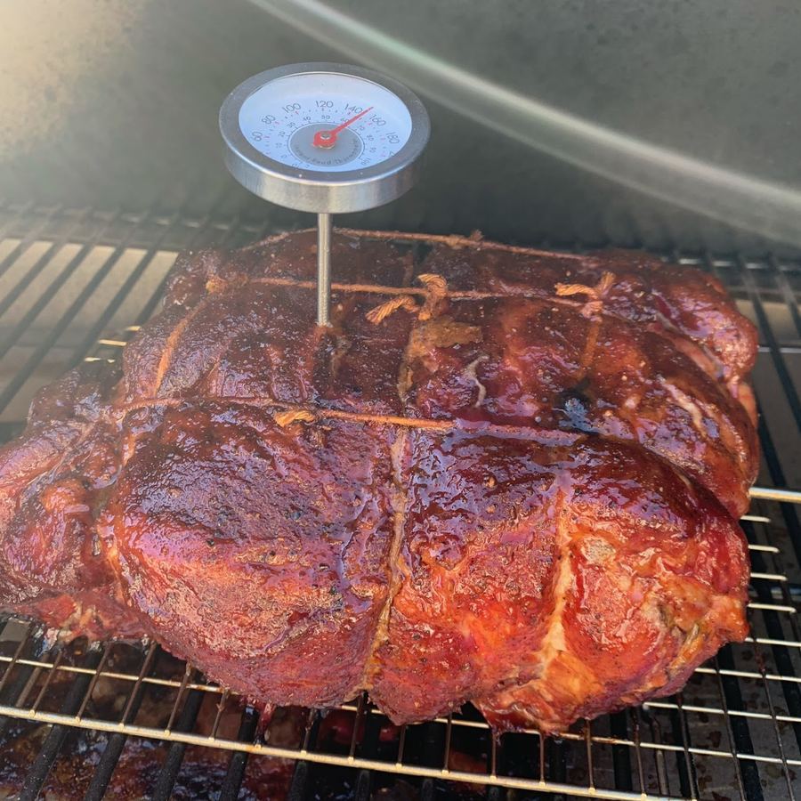 Pork shoulder smoking on a Traeger pellet grill during the first Italian Smokeshows smoke