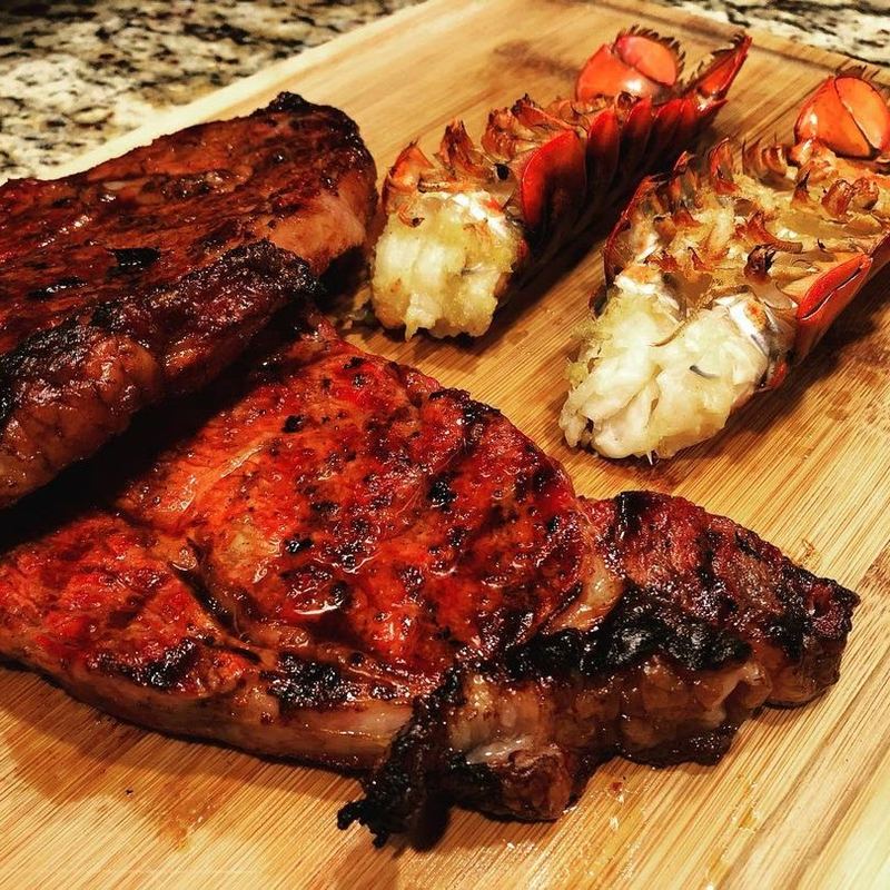Reverse sear ribeye steaks and lobster tails prepared for a backyard BBQ recipe