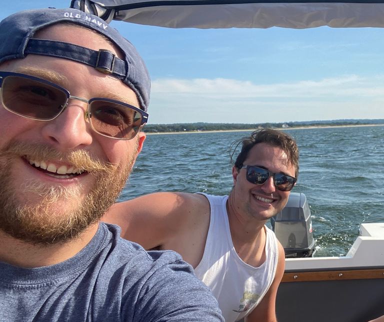 Sal and Nick, the Italian Smokeshows backyard BBQ team, smiling together on a boat